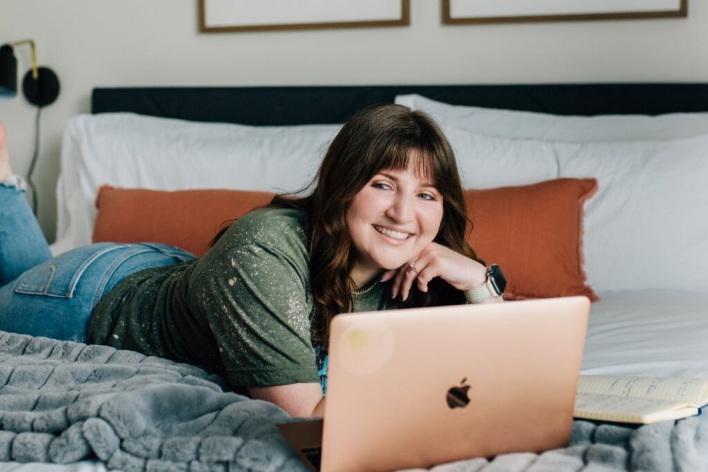 Digital nomad and laptop on a bed