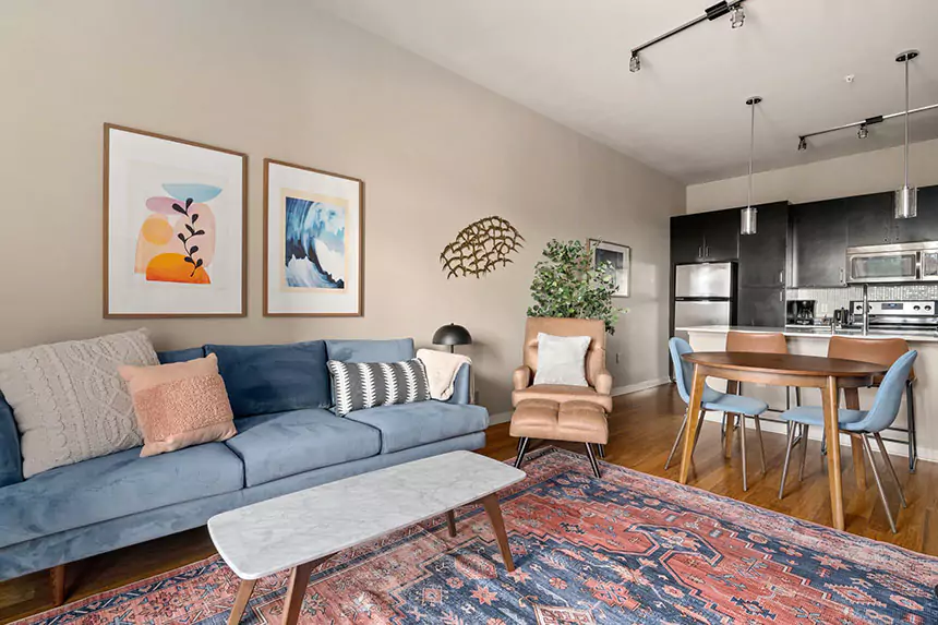 Living room with blue couch at Elan Med Center