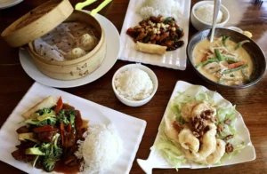 Generous portions of soup dumplings, stir fry and rice at Spicy Girl Szechuan in Midtown