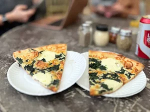 Spinach and ricotta pizza by the slice