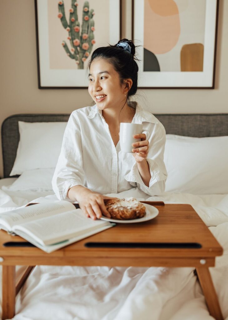 woman with a bed tray in a Lodgeur furnished apartment
