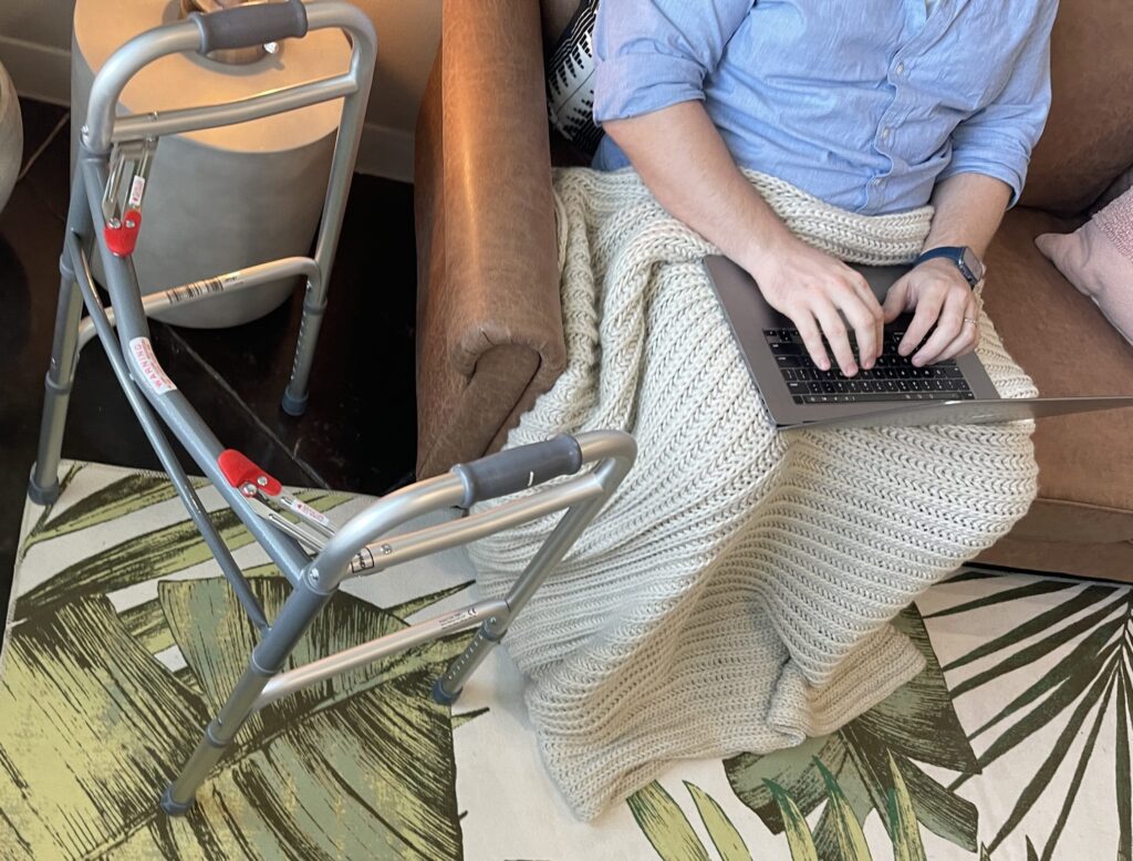 Lodgeur guest on a sofa next to a walker