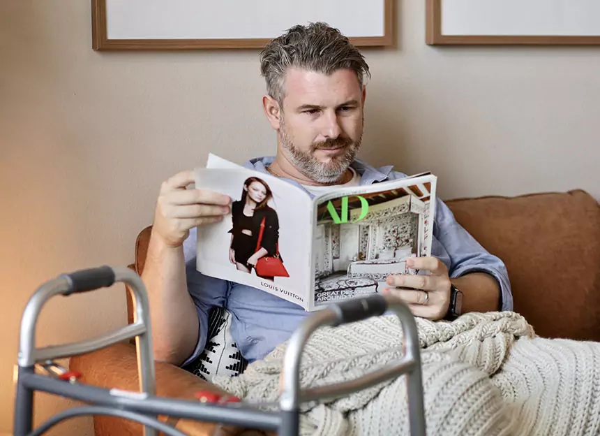 a man sitting on the couch reading
