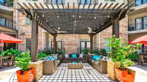 Outdoor seating by the pool for the Lodgeur at Elan Med Center apartment community