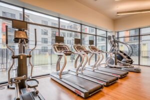 Cardio equipment at the fitness center of Mid Main Lofts