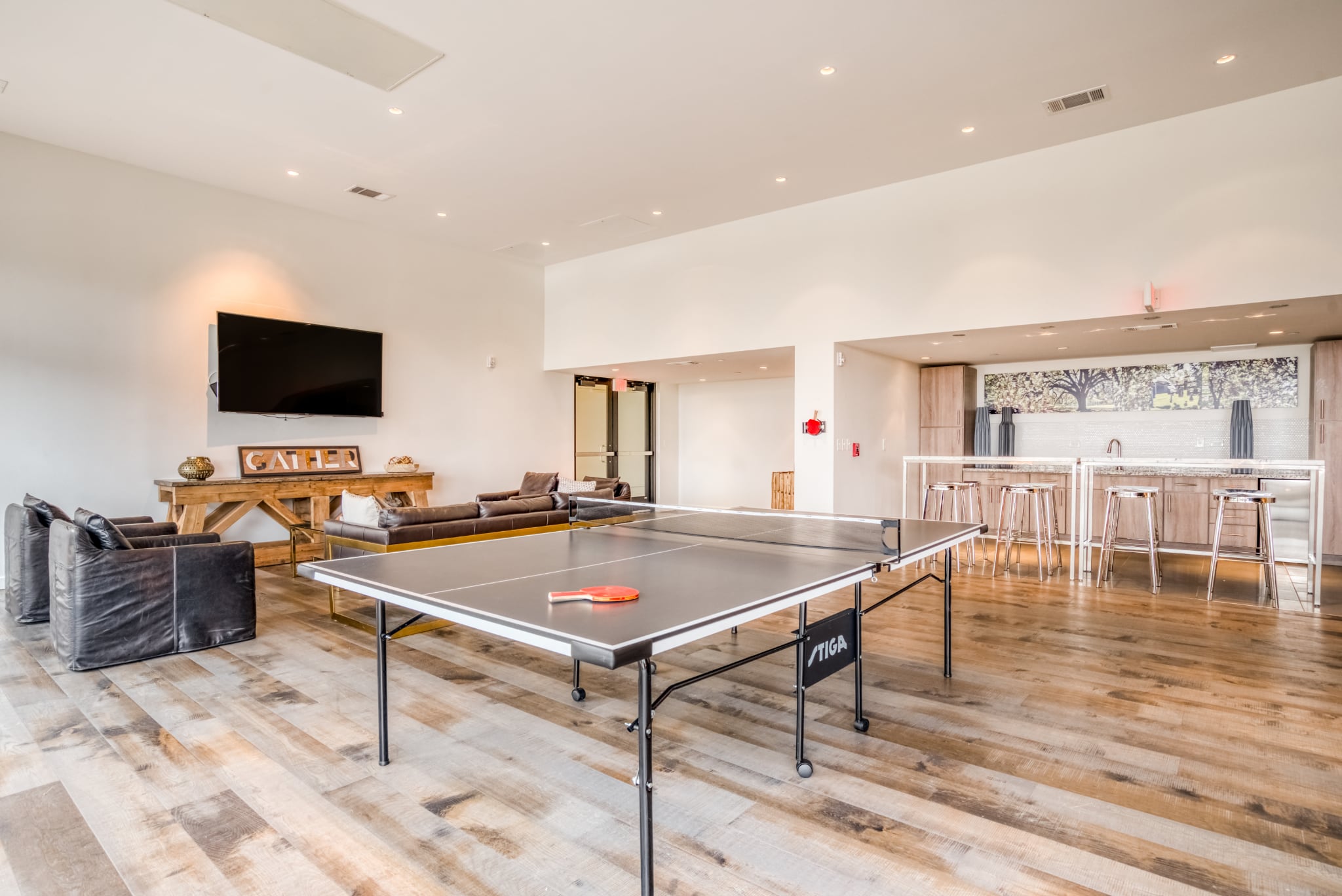 The residents' lounge at Mid Main Lofts showing a ping pong table, kitchen, and TV lounge