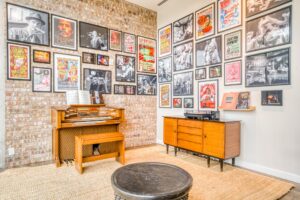 The ground floor residents' lounge at Mid Main Lofts featuring art, photos, and posters from the neighboring Continental Club, and an organ