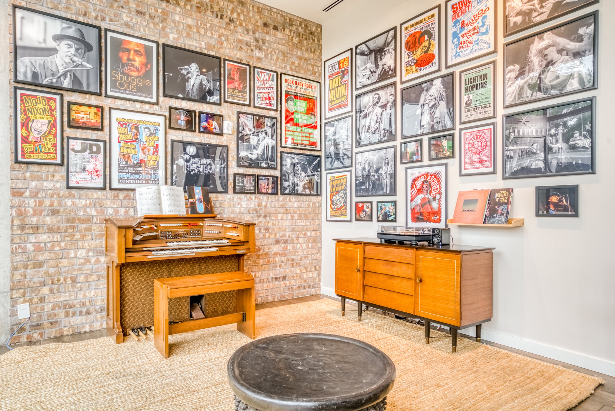 The ground floor residents' lounge at Mid Main Lofts featuring art, photos, and posters from the neighboring Continental Club, and an organ