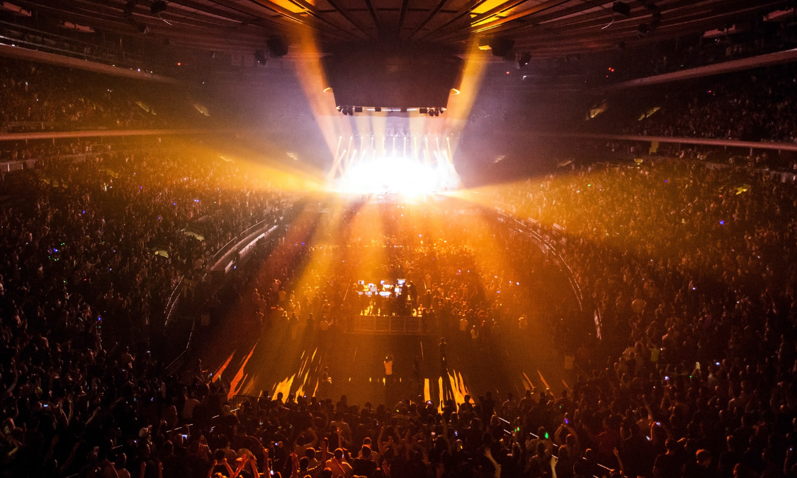 A lively concert with colorful lights and a crowd of excited fans.