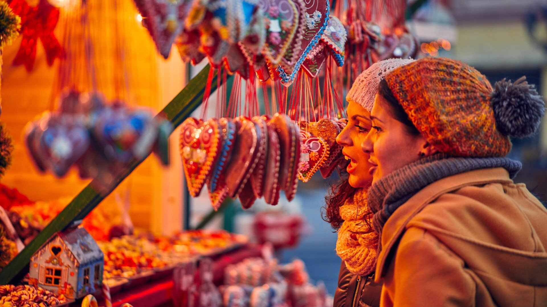 Women admiring a display of Christmas decorations