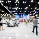 blurred photo of motor show, car show room