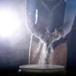 gymnast powdering her hands
