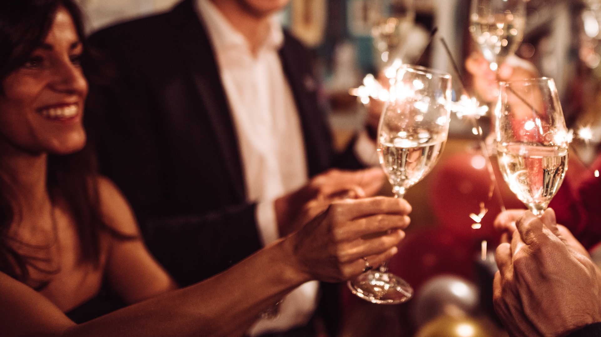 people raising their glasses in a celebratory toast