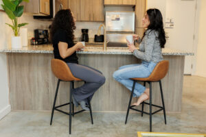 two women drinking coffee in a fully-equipped Lodgeur kitchen