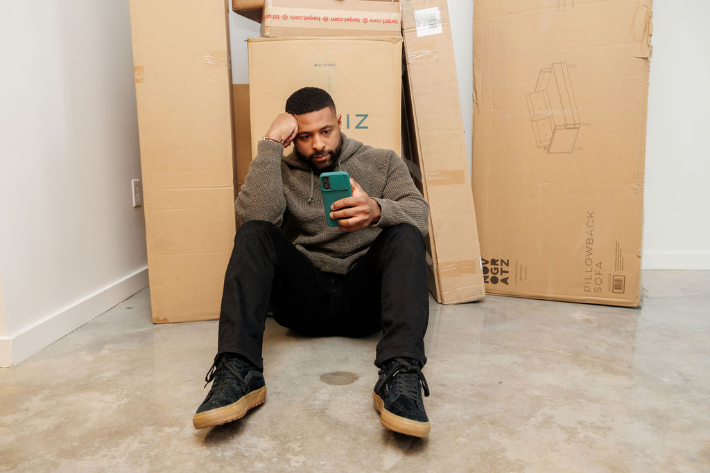 man in front of boxes