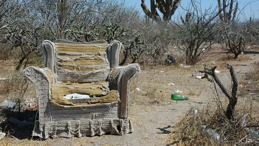 Image of a sad, damaged chair in the desert