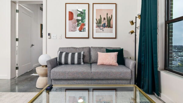 A comfortable couch positioned in a living room with a stunning scenic view visible through the large windows