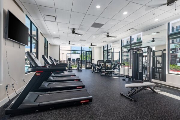 The gym with cardio and strength equipment at Lodgeur Energy Corridor