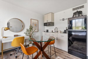 Desk, dining table and kitchenette at Lodgeur Upper Kirby
